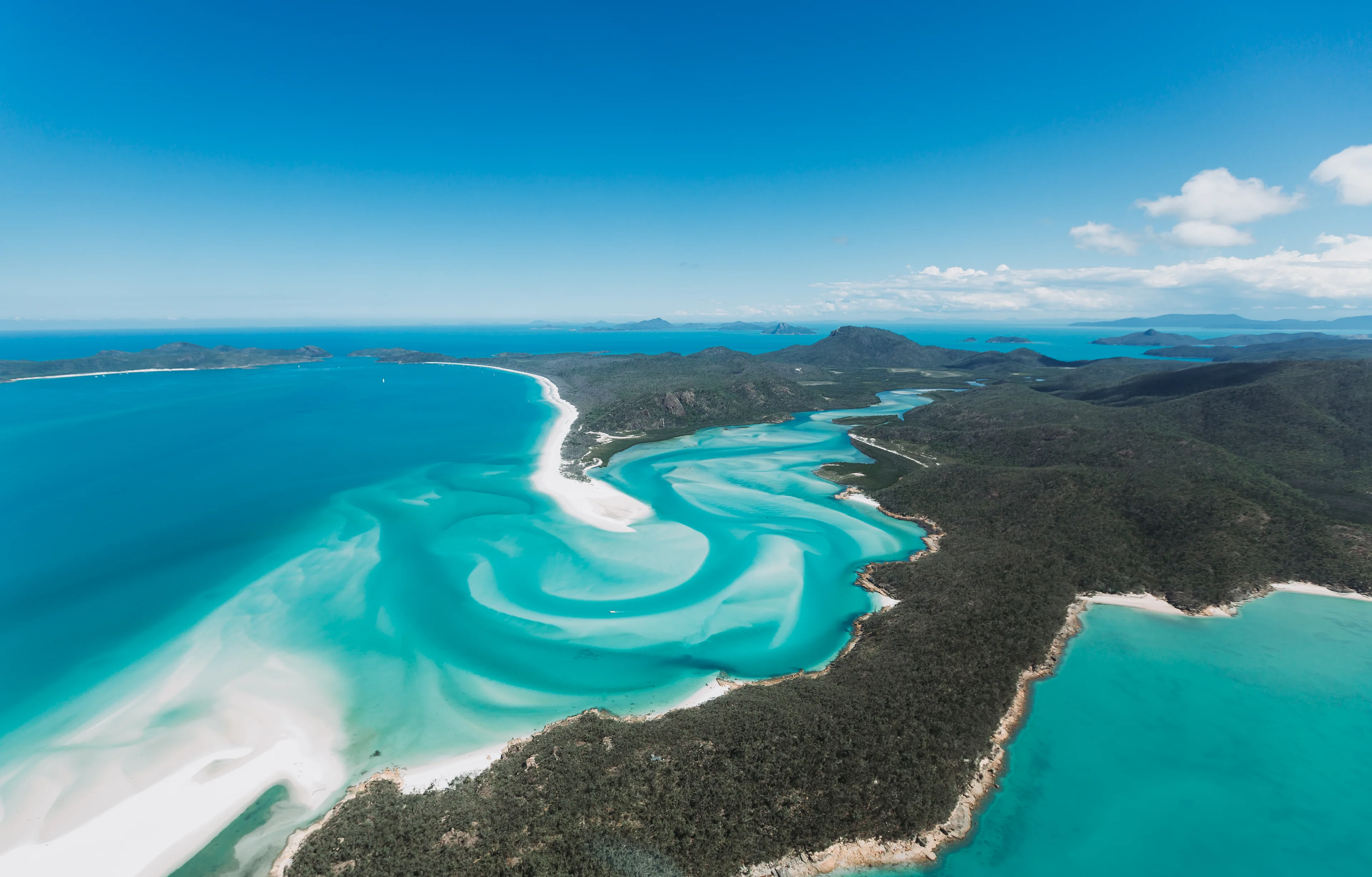 Aerial view overlooking the stunning turquoise waters and white sands of the Hill Inlet and Togue Bay in the Whitsundays